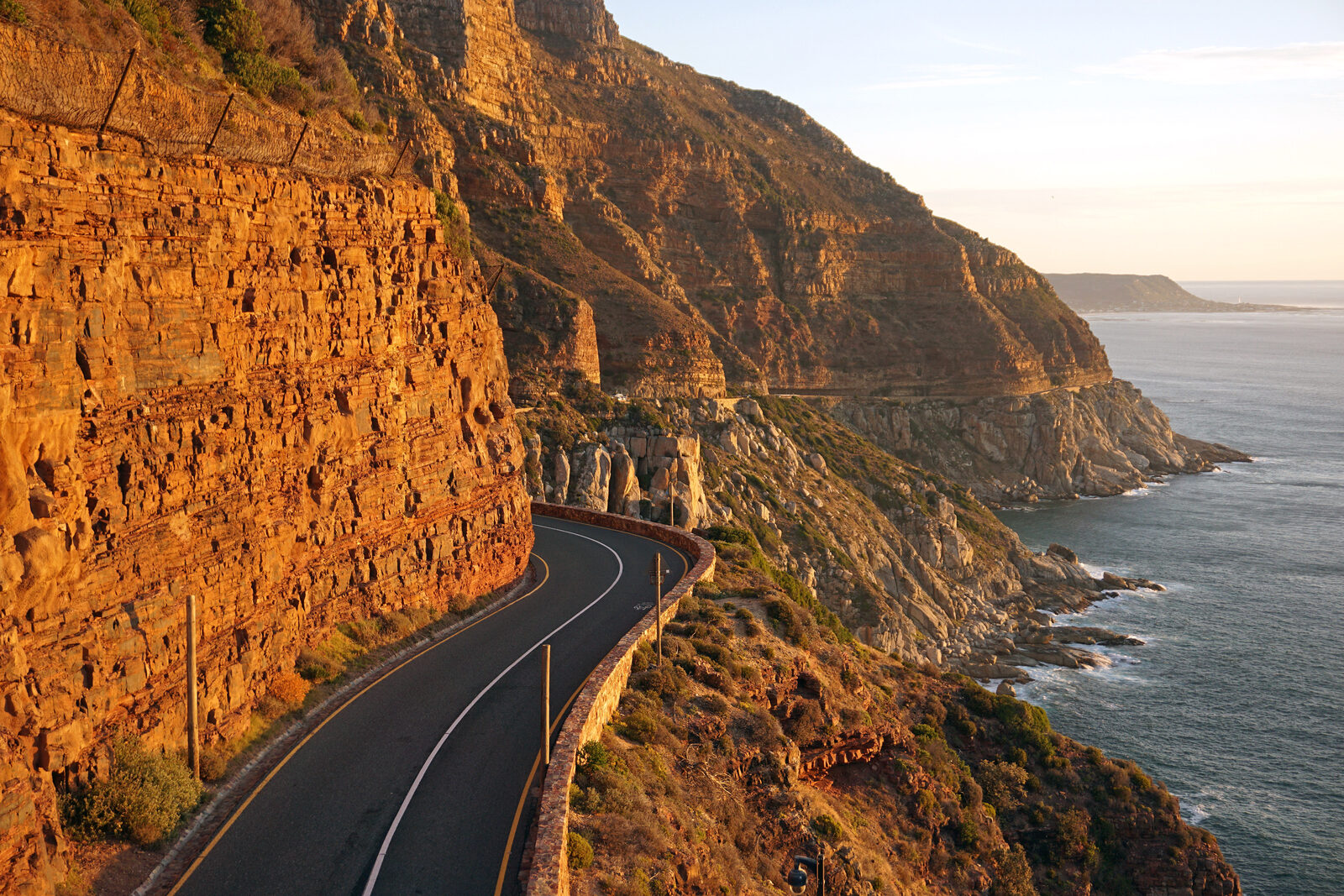 The winding coastal road of Chapmans Peak Drive carved into the cliff above the Atlantic Ocean