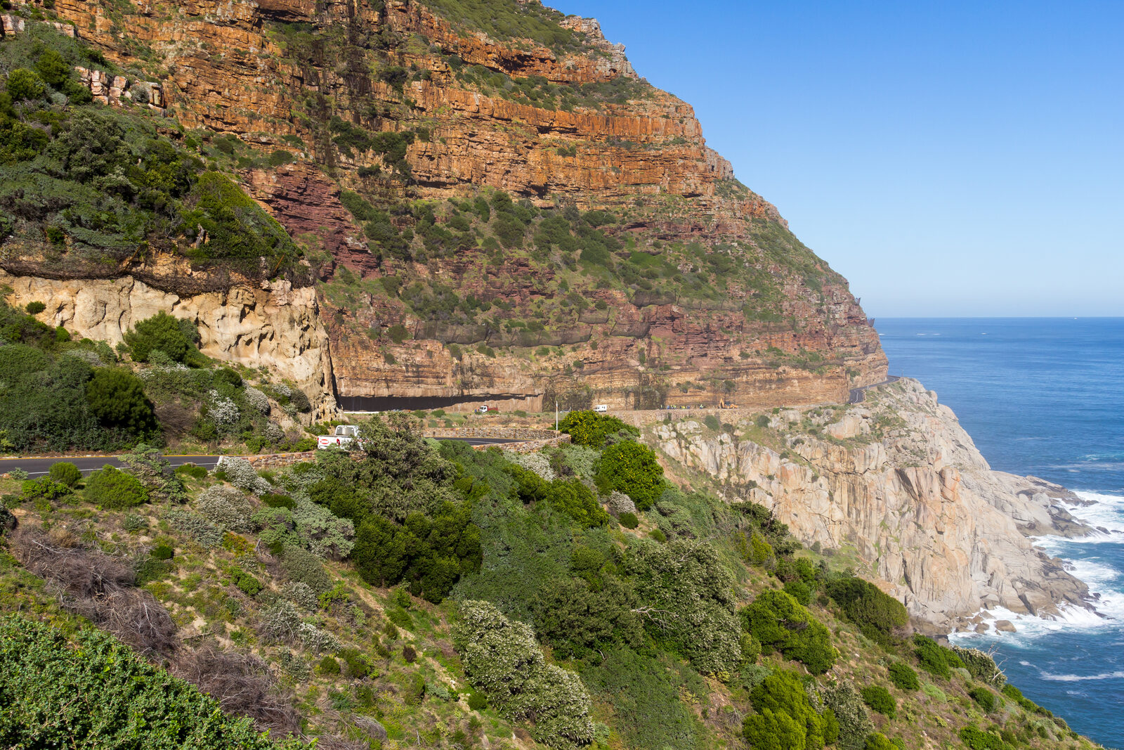Chapmans Peak mountain rising above the Atlantic coast seen from a distance